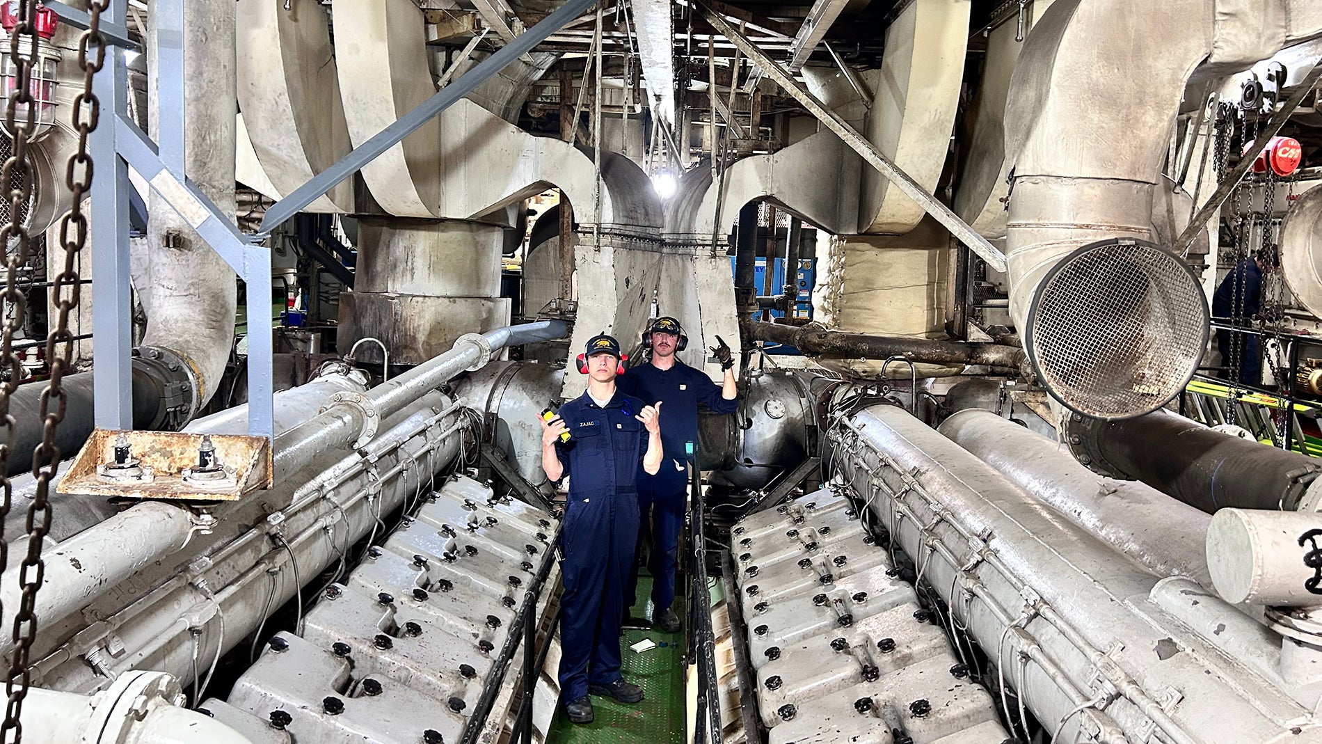 Two cadets pose in the working of the ship