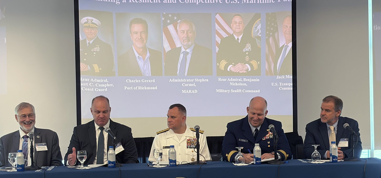 Maritime leaders sitting at a table during a panel discussion.