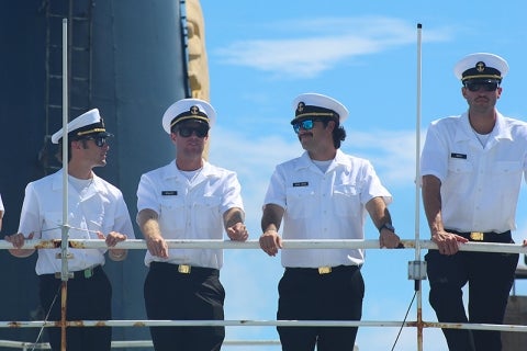 Four male cadets in uniform on the deck of TS Golden Bear