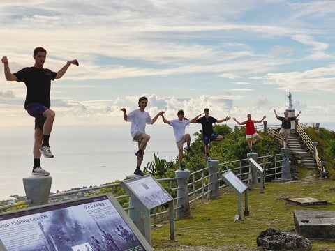 Students stand on posts at Mount Tapochau