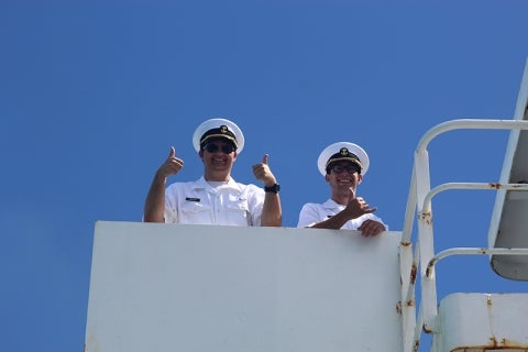 Two cadets give the thumbs up on the deck of TS Golden Bear
