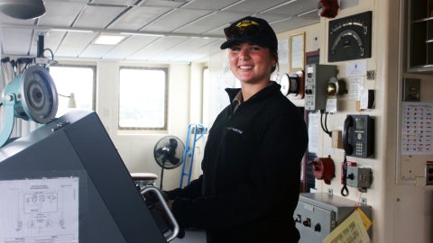 Boehlert standing at the helm of Training Ship Golden Bear, gaining hands-on experience at sea through the university’s Learn by Doing philosophy. 