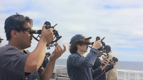Cadets using sextants aboard the Training Ship Golden Bear.