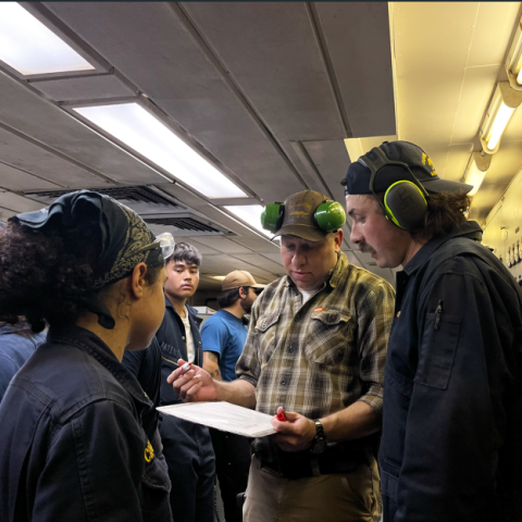 Chief Engineer Adam Kleitman works with Cadet Loden and his team to complete a checklist before starting the main engine.