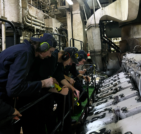  Cadet Loden showing the younger cadets where the main engine cylinder air cocks are located.