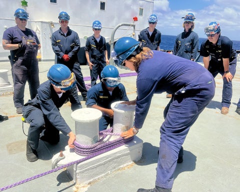 Deck cadets train on proper mooring techniques as part of hands-on maritime education.