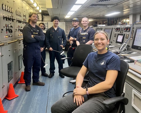 Cadets pose for a photo while watchstanding in the engine room.