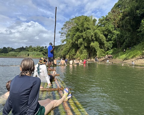 Cadets and crew cool off in a nearby river and ride homemade bamboo rafts during a day of cultural activities in Vuisiga Village. 