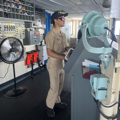 A cadet stands watch on the bridge of Training Ship Golden Bear.