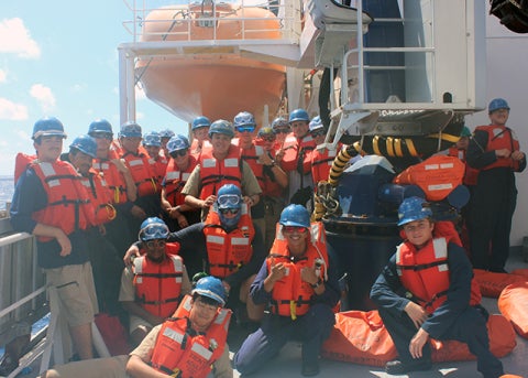 The crew standing in from of lifeboat 1 during fire and emergency drills.