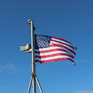 The American flag raised on a flagstaff of the Training Ship Golden Bear.