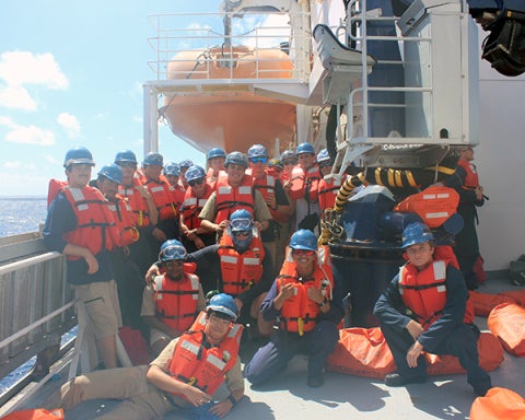 Cadets participating in a live fire drill on the deck of the Training Ship Golden Bear.