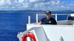 A student on TS Golden Bear as it approaches Guam
