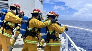 Cadets practice fire fighting on a ship