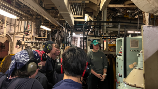 License Watch Officer Jessica Hebert explains the fundamentals of the oil-water separator system to cadets standing watch.  Photo by Maria "Maya" Barrozo, assistant purser, TSGB