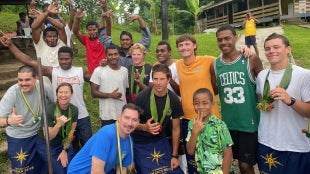 Capt. Samar B. Bannister, Cal Poly Maritime Academy cadets and residents of Vuisiga Village gather for a photo during a cultural excursion in Fiji.