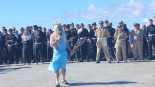 A Cal Poly Maritime Academy leader dressed up as King Neptune addresses cadets aboard Training Ship Golden Bear during the Sinbad Games.