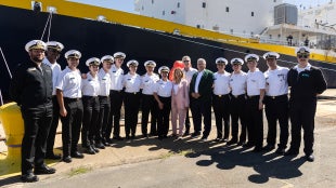 Cadets standing with Gov. Gavin Newsom and other leaders in front of the Training Ship Golden Bear.