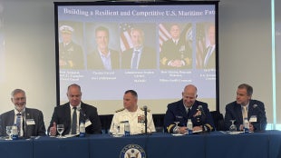 Maritime leaders sitting at a table during a panel discussion.