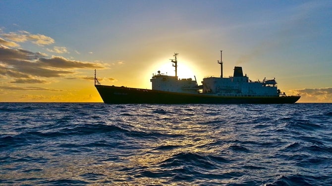 Ship in the distance against sunset 