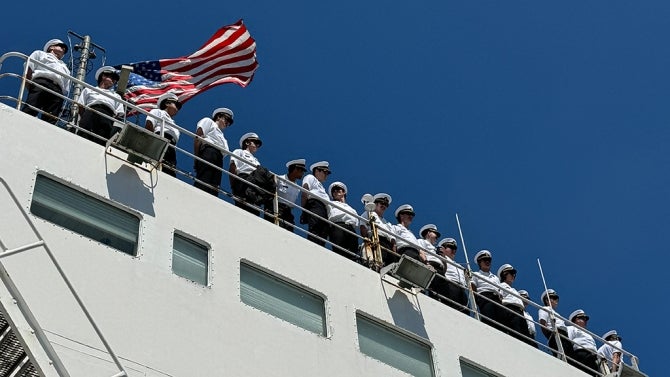 A lineup of students look out at sea